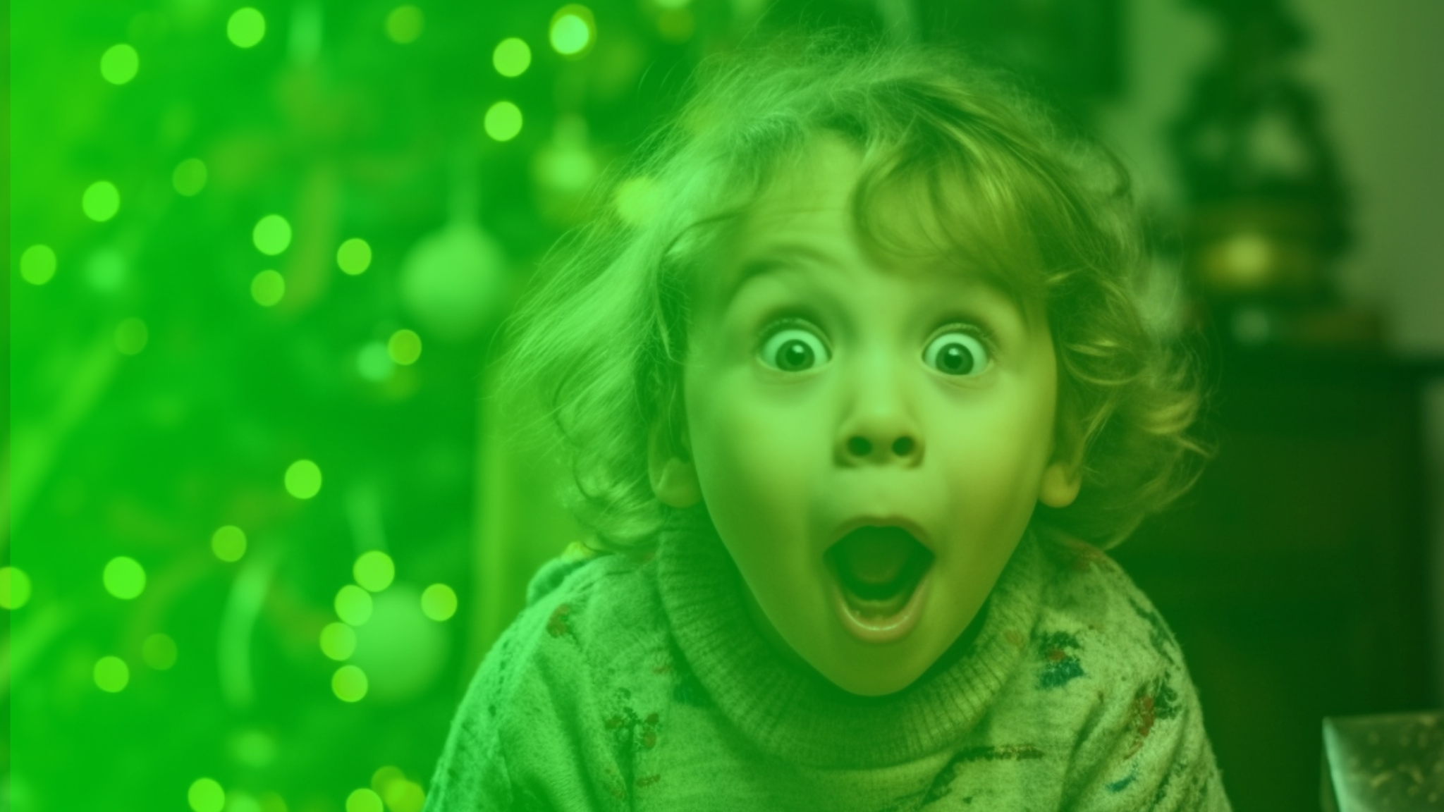 A young child with a surprised expression and wide eyes against a green bokeh background.